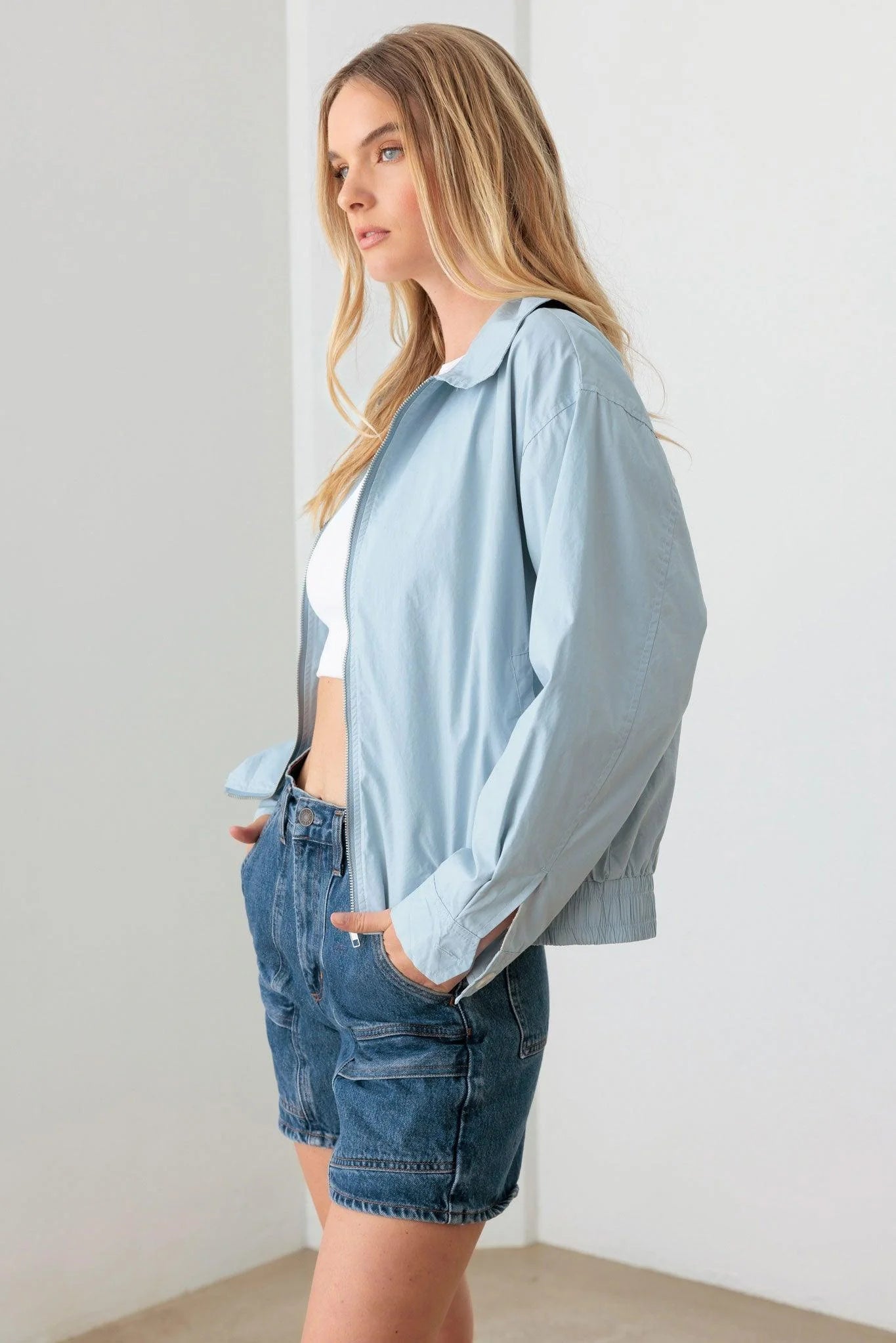 Model wearing baby blue relaxed fit collared jacket